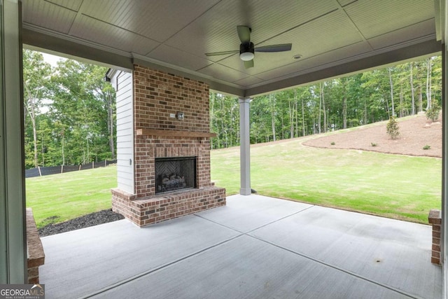 view of patio with ceiling fan and an outdoor brick fireplace