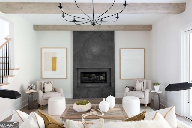 living room with beamed ceiling, wood finished floors, stairway, a fireplace, and baseboards