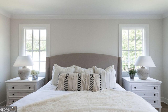 bedroom with multiple windows and ornamental molding