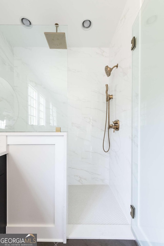 bathroom featuring a shower stall and vanity