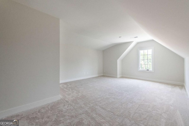 bonus room featuring lofted ceiling, baseboards, and carpet floors