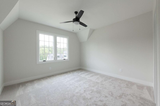 additional living space with baseboards, carpet floors, ceiling fan, and vaulted ceiling