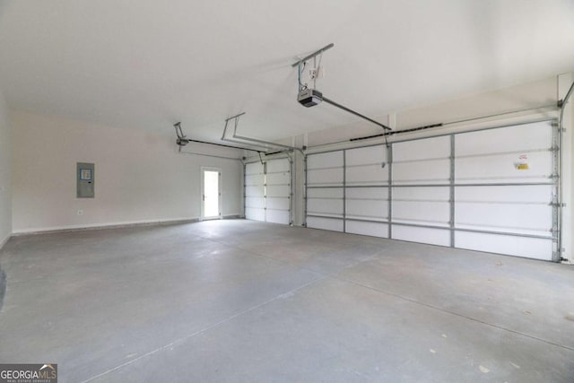 garage with electric panel and a garage door opener