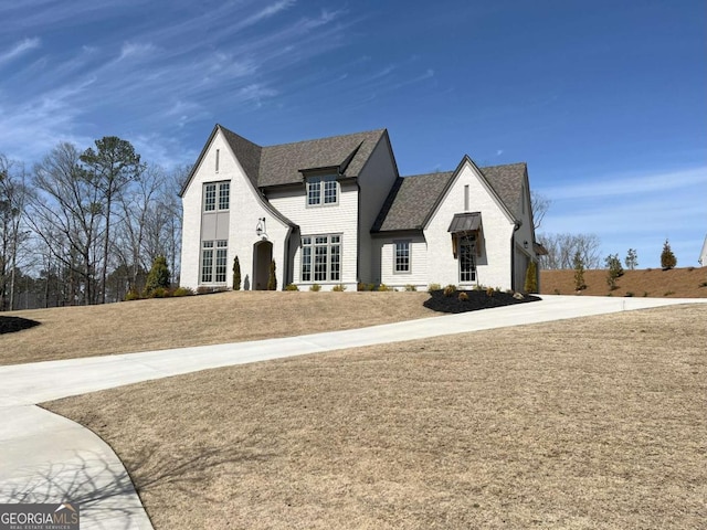 view of front of property with roof with shingles