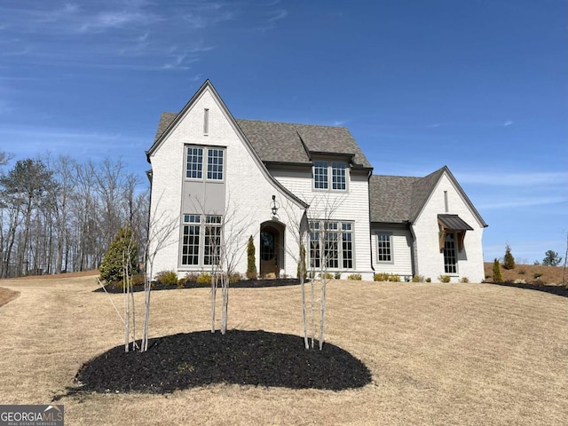 view of front of house with roof with shingles