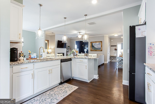 kitchen featuring dark wood-type flooring, white cabinets, appliances with stainless steel finishes, and a sink