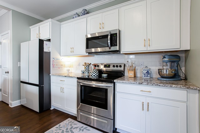 kitchen with crown molding, dark wood finished floors, decorative backsplash, appliances with stainless steel finishes, and white cabinetry