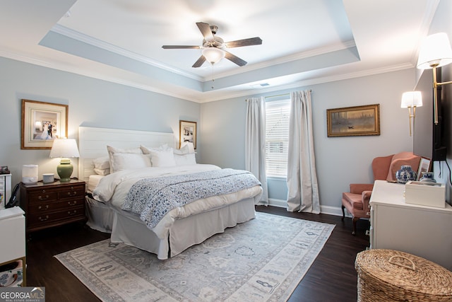 bedroom with a tray ceiling, baseboards, dark wood finished floors, and ornamental molding