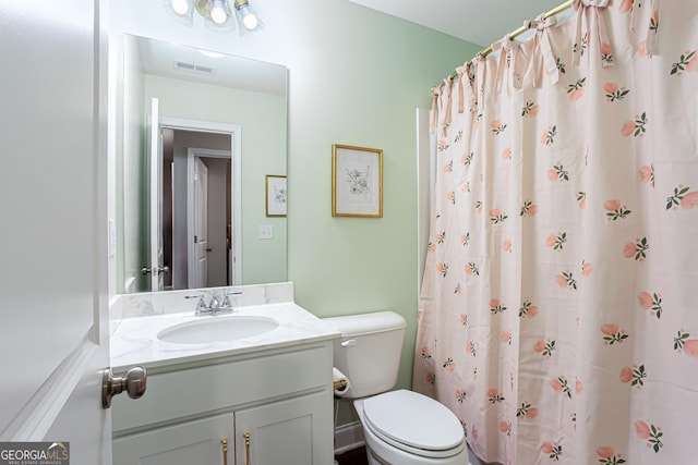 full bath with visible vents, curtained shower, toilet, and vanity