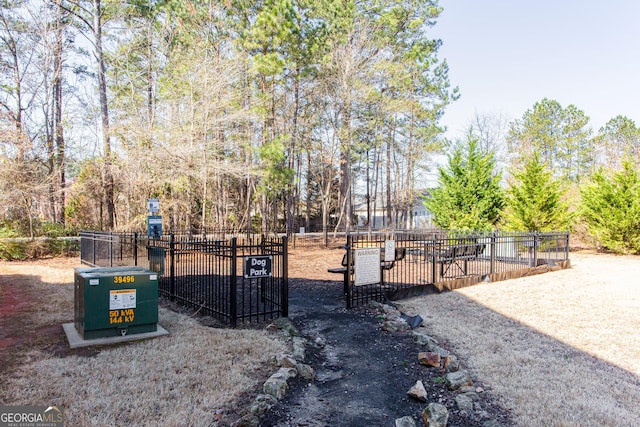 view of home's community with a gate and fence