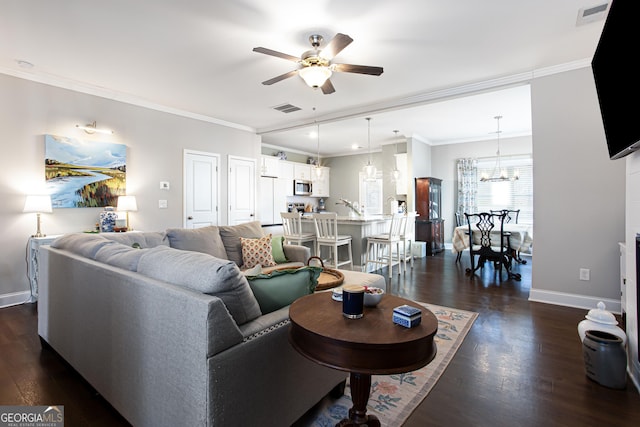 living area featuring visible vents, dark wood finished floors, crown molding, and ceiling fan with notable chandelier