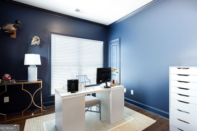 office space with crown molding, wood finished floors, visible vents, and baseboards