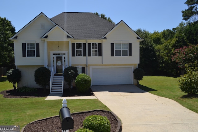 bi-level home featuring driveway, roof with shingles, an attached garage, stucco siding, and a front lawn