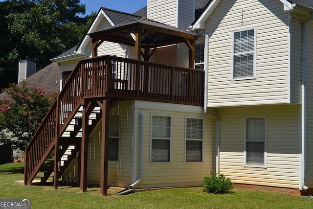 view of jungle gym with stairs, a lawn, and a wooden deck