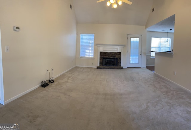 unfurnished living room featuring high vaulted ceiling, carpet floors, a fireplace, baseboards, and ceiling fan