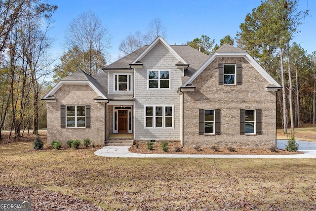 craftsman house featuring a front lawn, brick siding, and roof with shingles