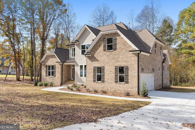 view of front of property featuring brick siding, concrete driveway, a garage, and roof with shingles