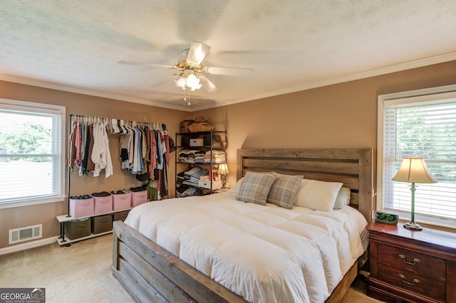 bedroom with visible vents, multiple windows, light carpet, and crown molding