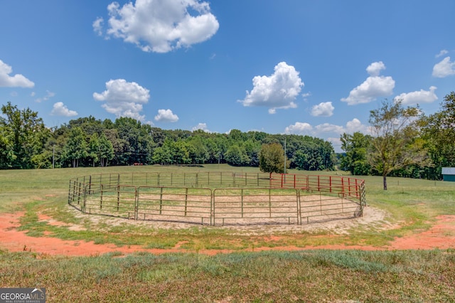 view of yard featuring a rural view and an enclosed area