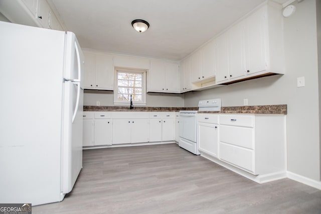 kitchen with light wood finished floors, white appliances, white cabinetry, and a sink