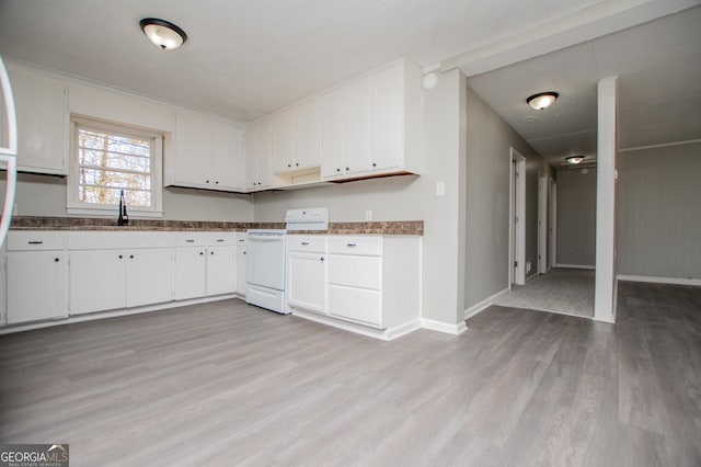 kitchen with light wood finished floors, white cabinets, white electric stove, and a sink