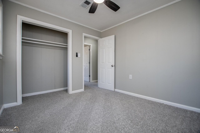 unfurnished bedroom with carpet, baseboards, visible vents, ornamental molding, and a closet