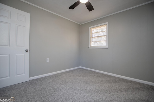 carpeted empty room featuring crown molding, a ceiling fan, and baseboards