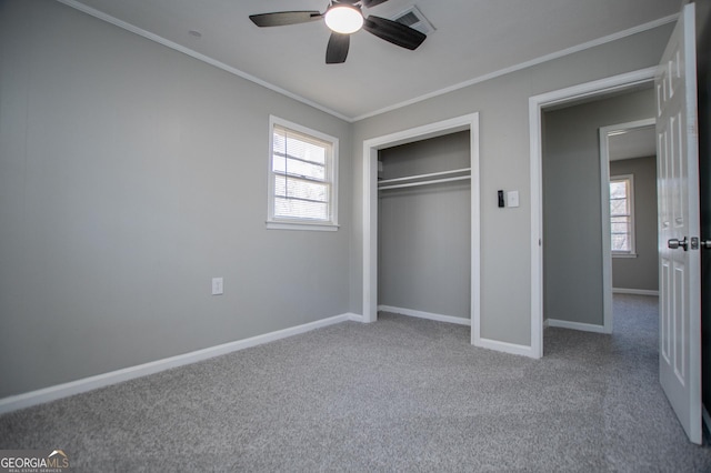 unfurnished bedroom featuring carpet, visible vents, baseboards, ornamental molding, and a closet