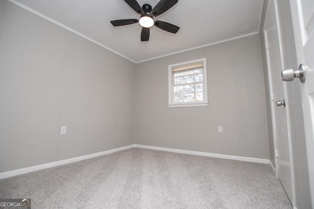 unfurnished room with ceiling fan, crown molding, baseboards, and carpet floors