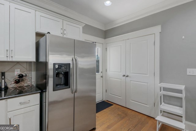 kitchen featuring light wood-type flooring, white cabinetry, crown molding, and stainless steel fridge with ice dispenser