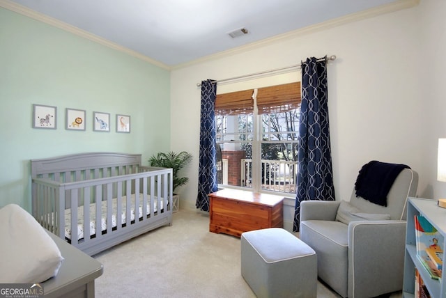 carpeted bedroom with visible vents, a crib, and crown molding