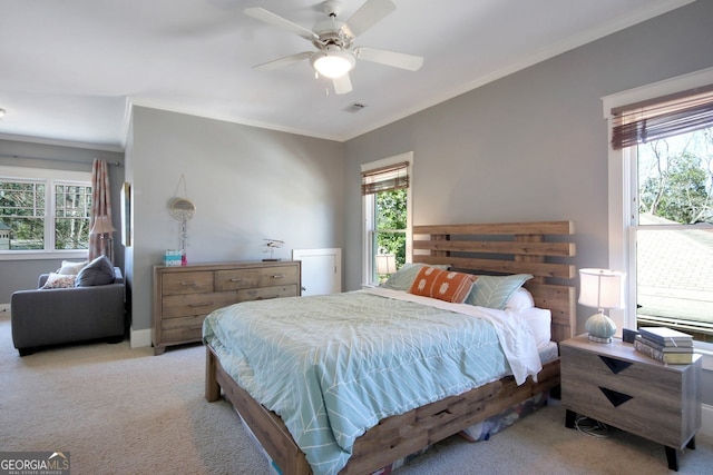 bedroom with light colored carpet, ornamental molding, and multiple windows