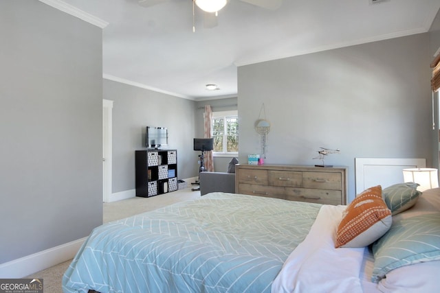 carpeted bedroom with baseboards, ceiling fan, and crown molding