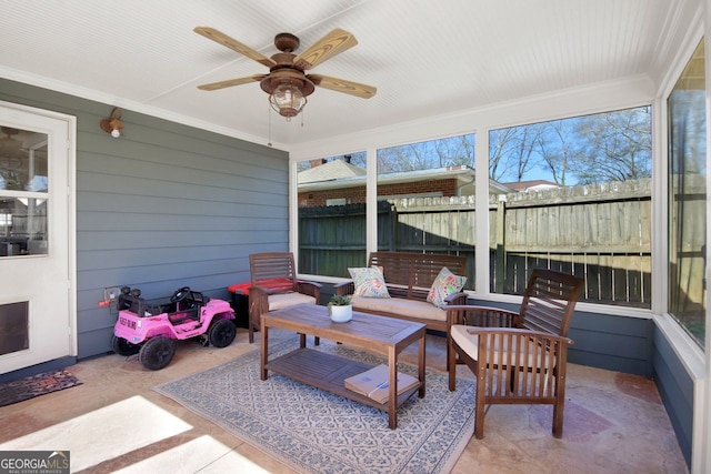 sunroom featuring ceiling fan