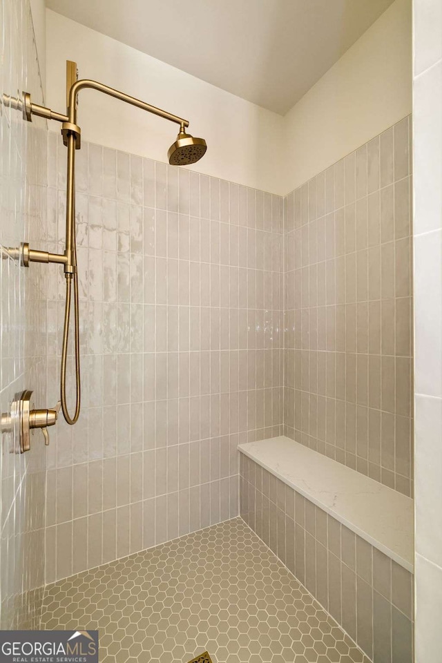 bathroom with a tile shower