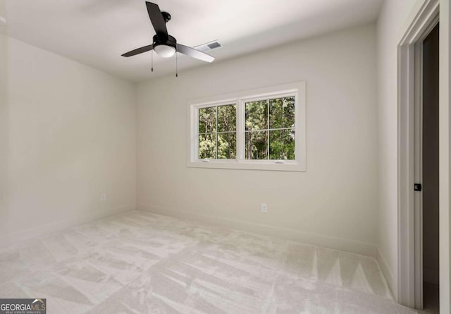 spare room featuring visible vents, baseboards, a ceiling fan, and carpet flooring