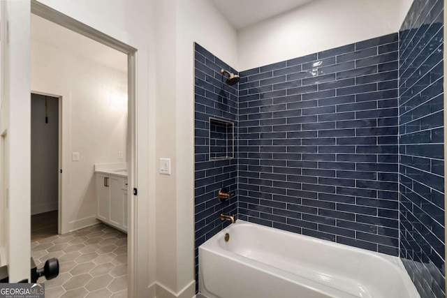 full bathroom with tile patterned floors, tub / shower combination, vanity, and baseboards