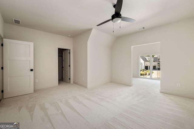 unfurnished bedroom featuring carpet flooring, a ceiling fan, and visible vents