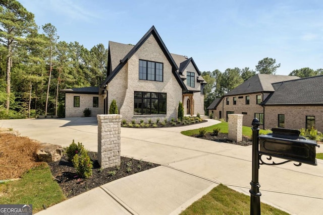 view of front of home featuring concrete driveway and brick siding