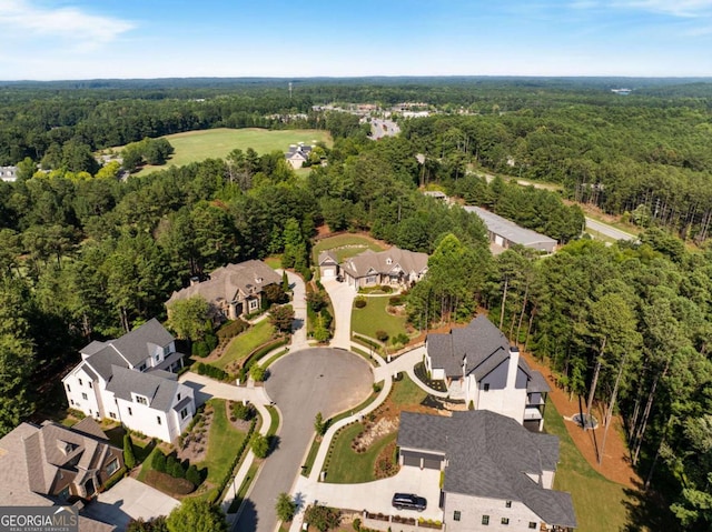 birds eye view of property featuring a forest view and a residential view