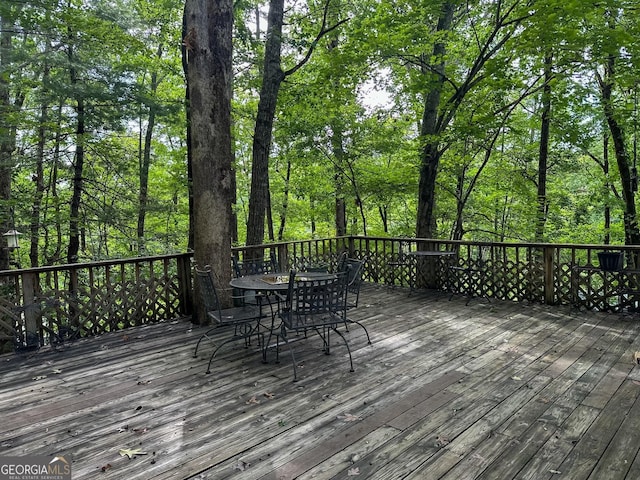 wooden terrace featuring outdoor dining space