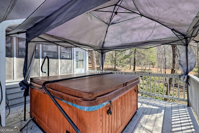 wooden deck with a hot tub