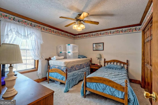 carpeted bedroom featuring ceiling fan, crown molding, baseboards, and a textured ceiling