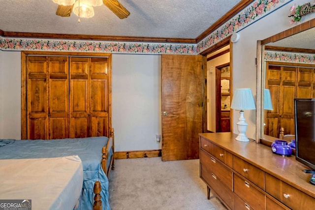 bedroom featuring crown molding, baseboards, light colored carpet, a textured ceiling, and a ceiling fan