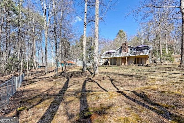 view of yard with fence and a wooden deck