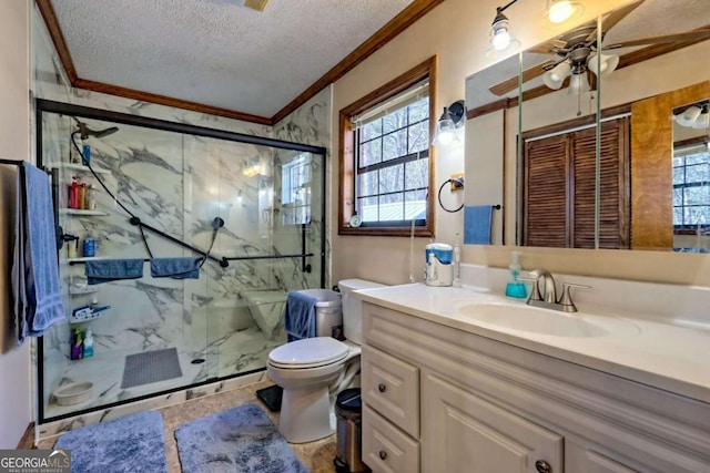 full bath featuring vanity, a marble finish shower, a textured ceiling, crown molding, and toilet