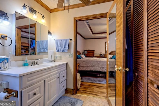 bathroom with a closet, connected bathroom, vanity, and ornamental molding