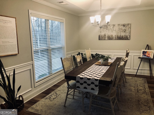 dining room featuring visible vents, ornamental molding, a wainscoted wall, and dark wood-style flooring