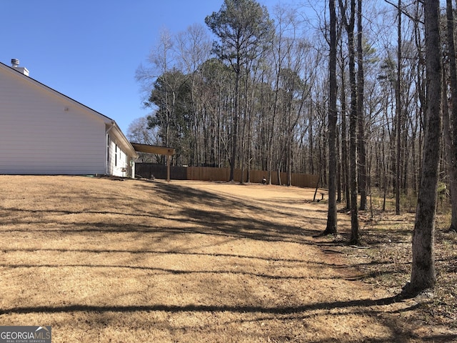 view of yard featuring a carport and fence