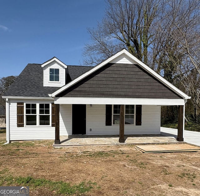 exterior space with roof with shingles